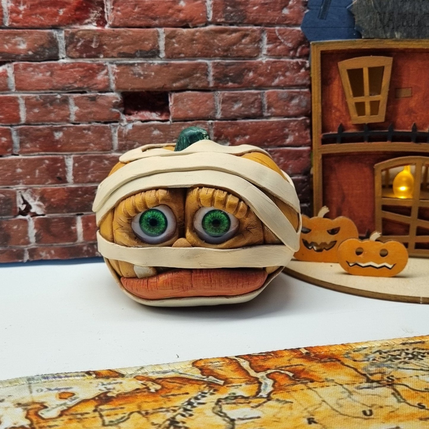 Handmade Mummy Pumpkin Decoration – Polymer Clay Halloween Figurine with Green Cabochon Eyes