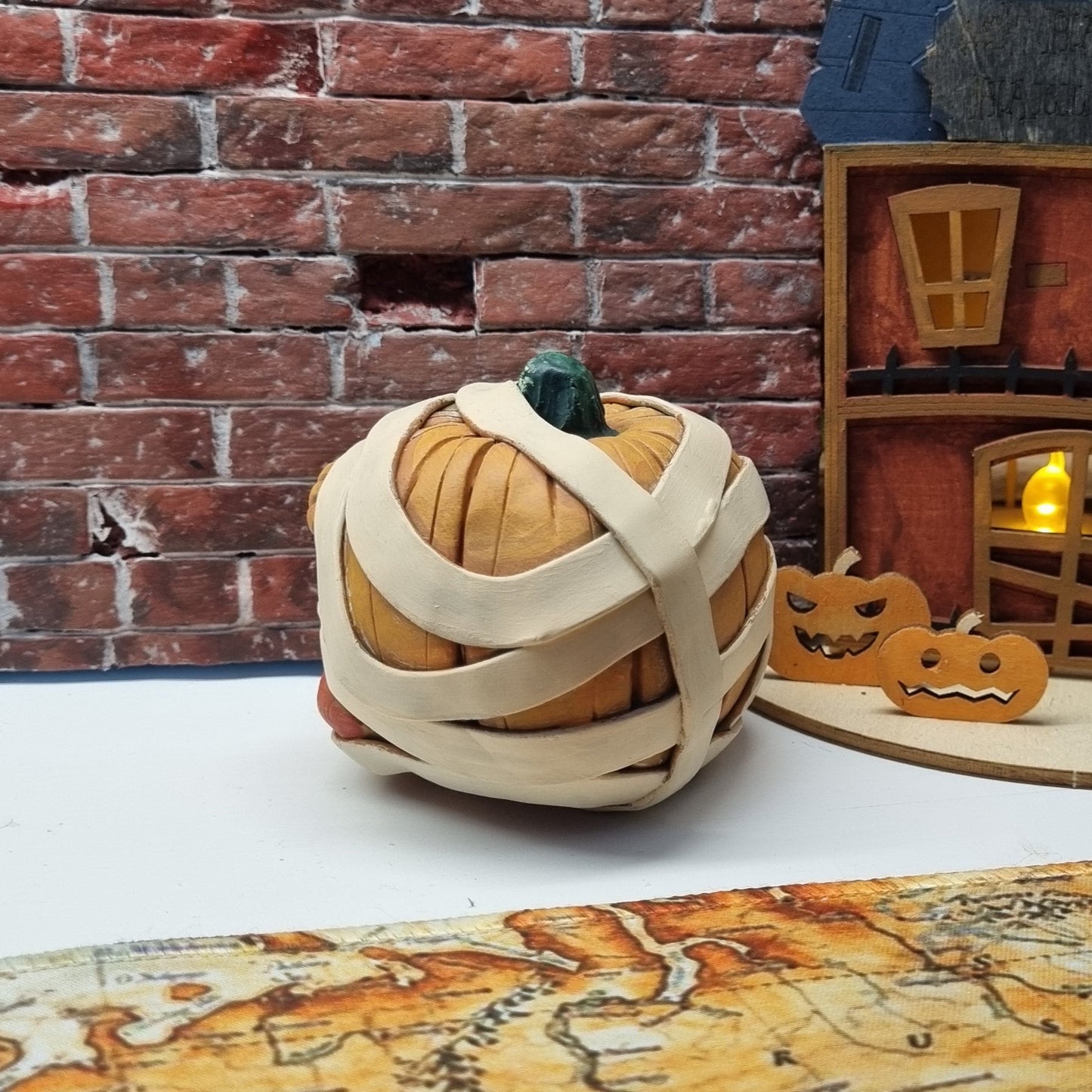 Handmade Mummy Pumpkin Decoration – Polymer Clay Halloween Figurine with Green Cabochon Eyes
