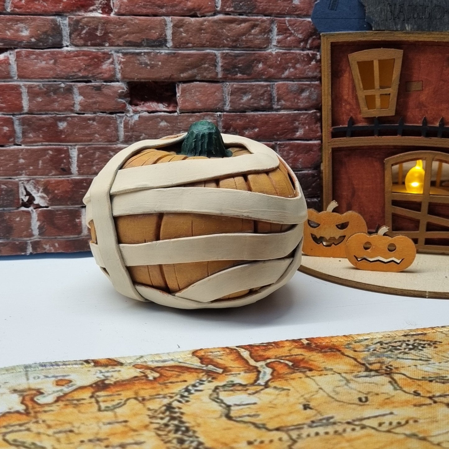 Handmade Mummy Pumpkin Decoration – Polymer Clay Halloween Figurine with Green Cabochon Eyes