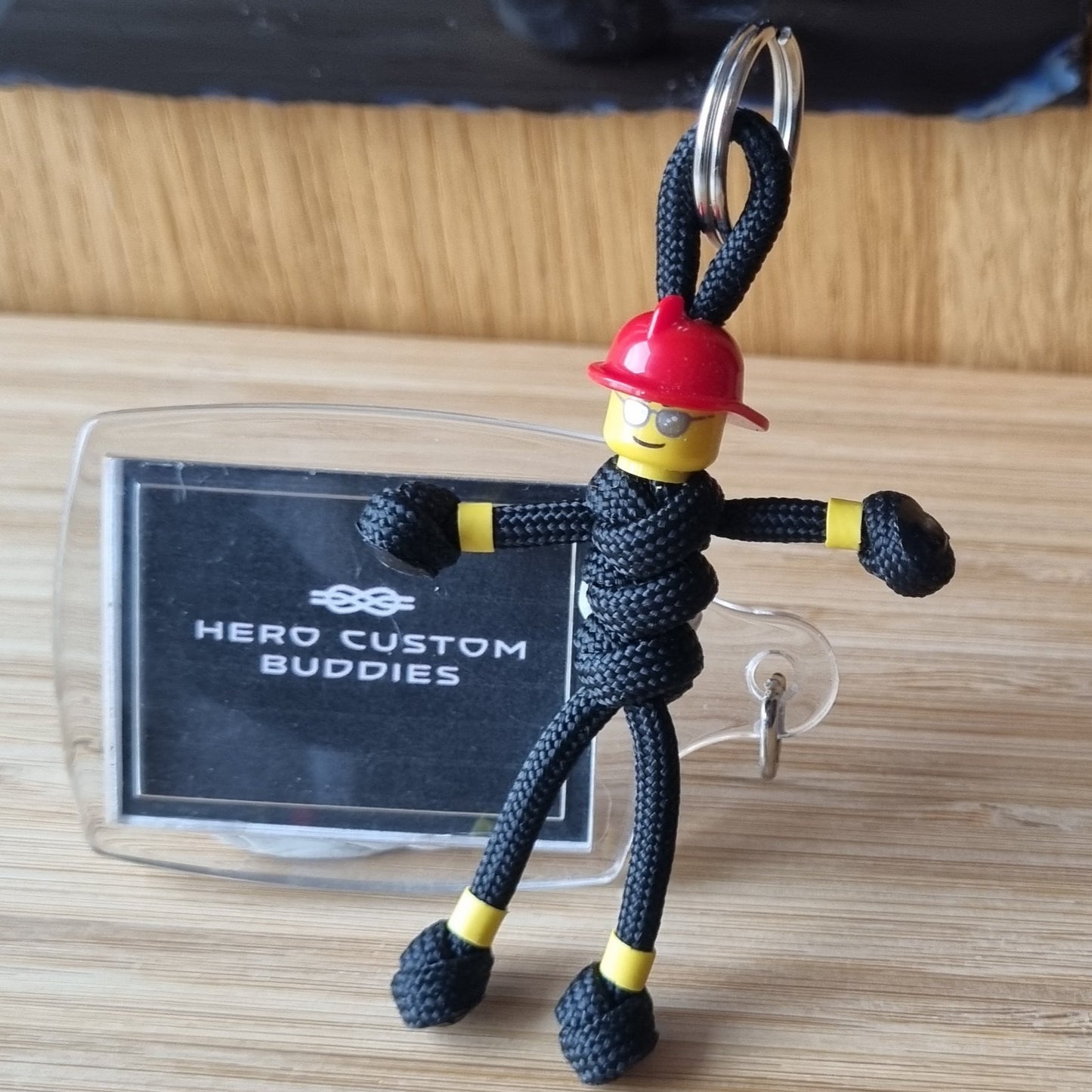 Male firefighter keychains made with black paracord and red building block helmet